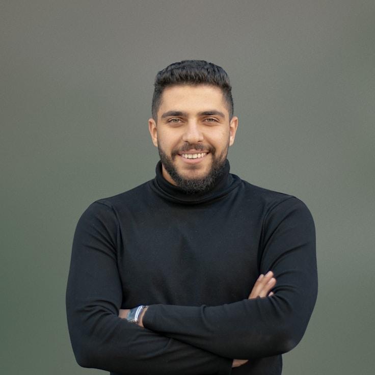 Alex Carter, Lead Design Curator at Current Common Studio, reviewing corporate floral arrangements